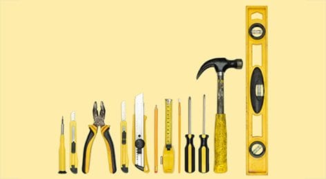 a bunch of yellow tools are lined up on a yellow background .